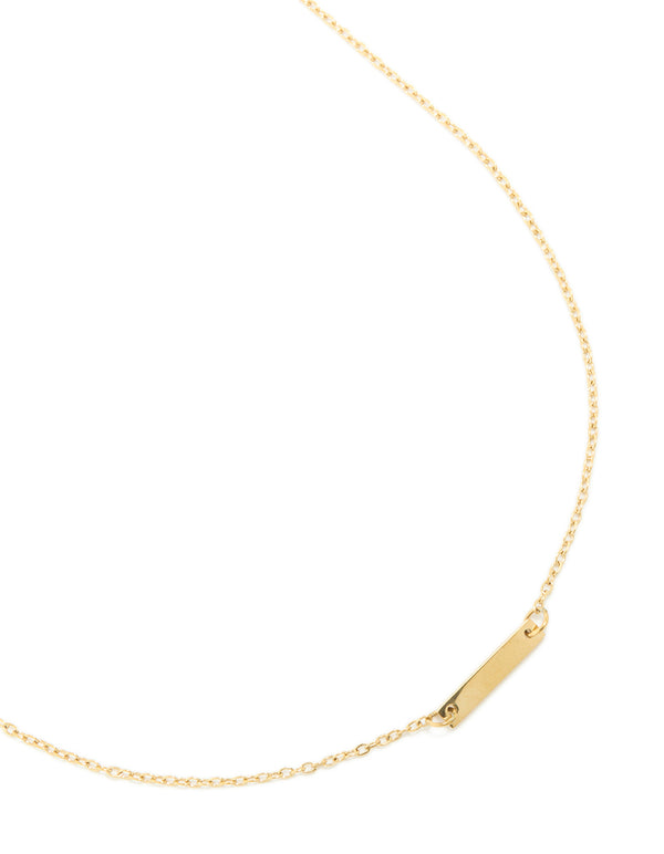 Displaying a waterproof mini engravable bar necklace in gold plated stainless steel with dainty style close up view