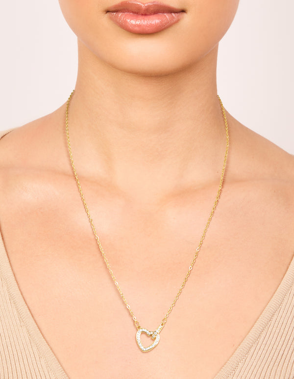 Showcasing a waterproof gold plated stainless steel hollow heart necklace with cubic zirconia pendant on neck view