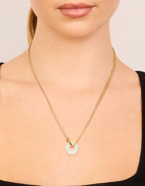 Showcasing a waterproof pendant necklace crafted from gold plated stainless steel with food-inspired doughnut design on neck view