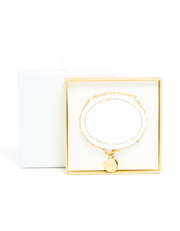 A waterproof stainless steel beloved T & O bracelet featuring script in dainty gold close up view
