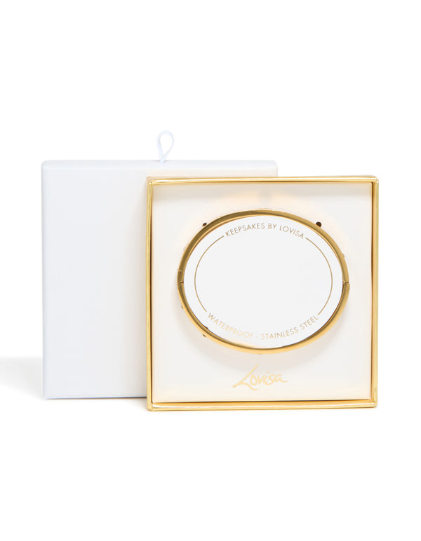 A waterproof gold plated stainless steel cubic zirconia flower bangle presented in branded packaging closure detail view