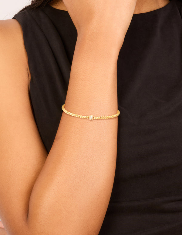 Showcasing a waterproof gold plated stainless steel cubic zirconia ball tennis stretch bracelet with beaded design on wrist view