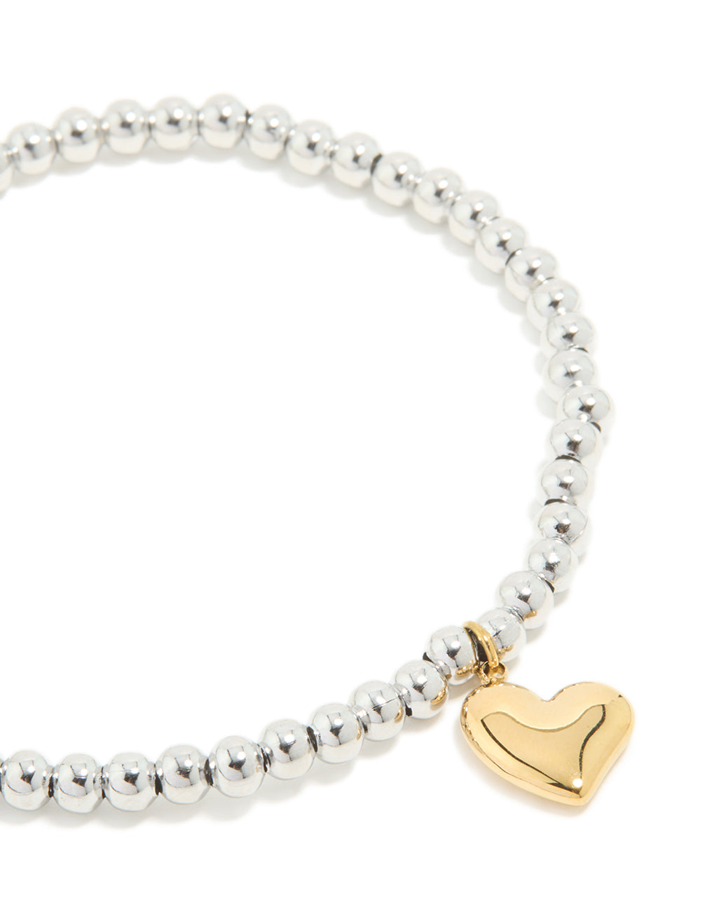 A waterproof stainless steel heart pendant stretch bracelet with beads gold plated details in silver close up view