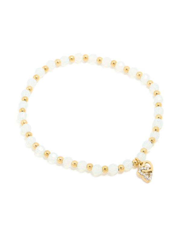 Crafted from waterproof gold plated stainless steel, this beaded stretch bracelet features clear quartz stones and a dainty heart charm front view