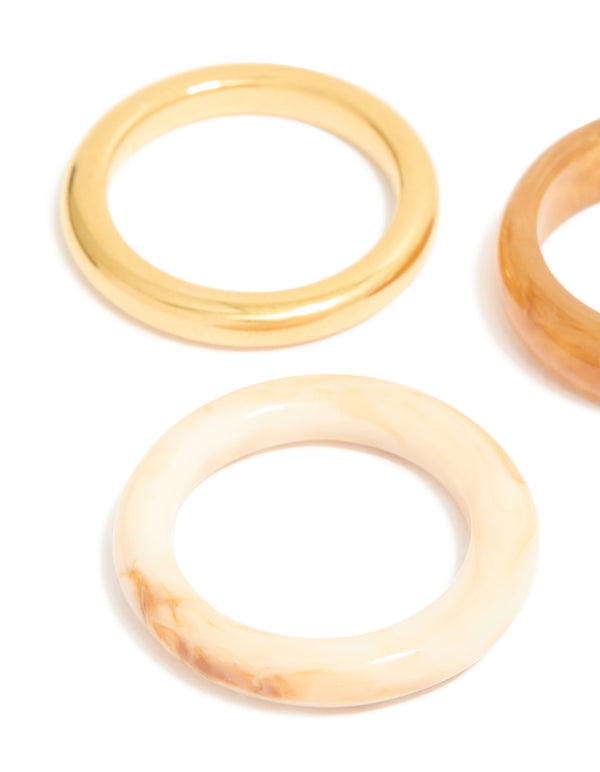 Designed with waterproof gold plated stainless steel and marbled finishes as stacking rings in a 3-pack close up view