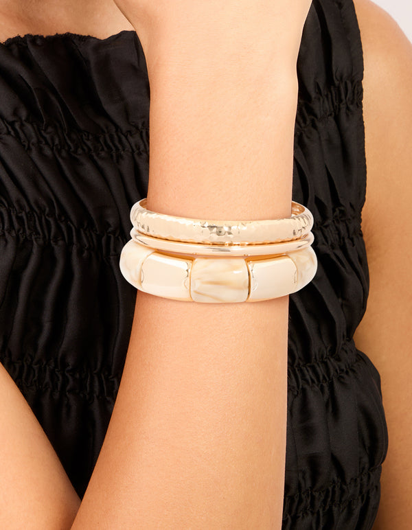 Showcasing cream acrylic stretch bangle and bangles in a 3-pack on wrist view