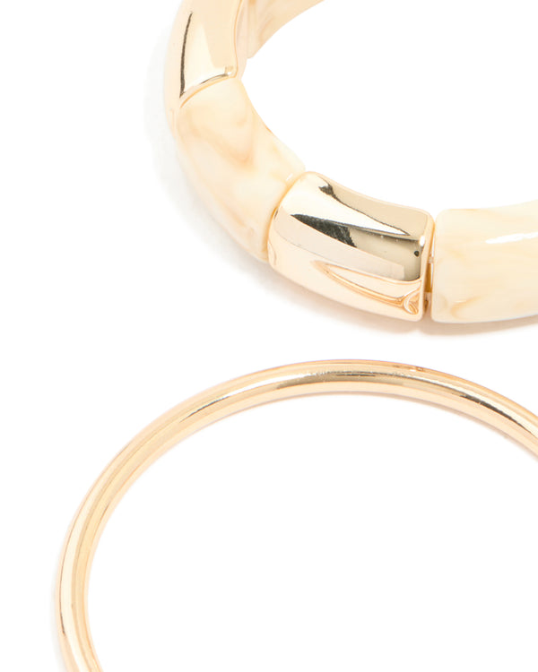 Designed with cream acrylic stretch bangle and bangles in a 3-pack close up view