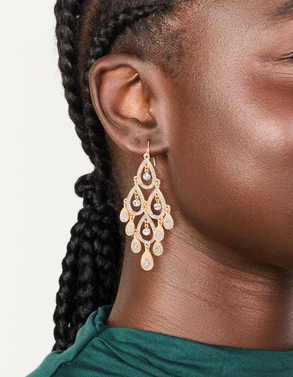 Showcasing gold diamante diamond shaped dangly earrings with charm details on ear view