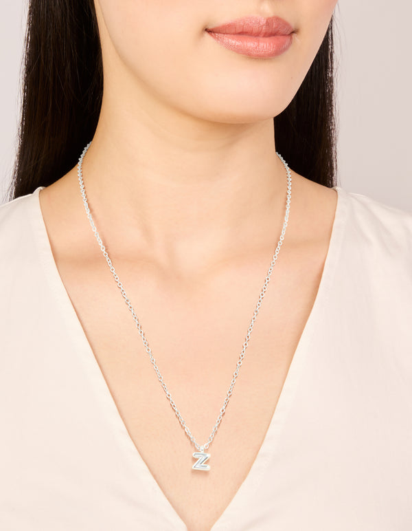Showcasing a waterproof stainless steel mini bubble letter Z necklace with initial pendant in silver and dainty design on neck view