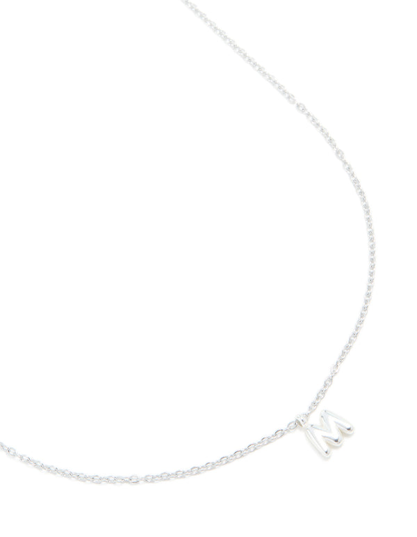 Showcasing a waterproof stainless steel mini bubble letter M necklace with initial pendant in silver plated color close up view