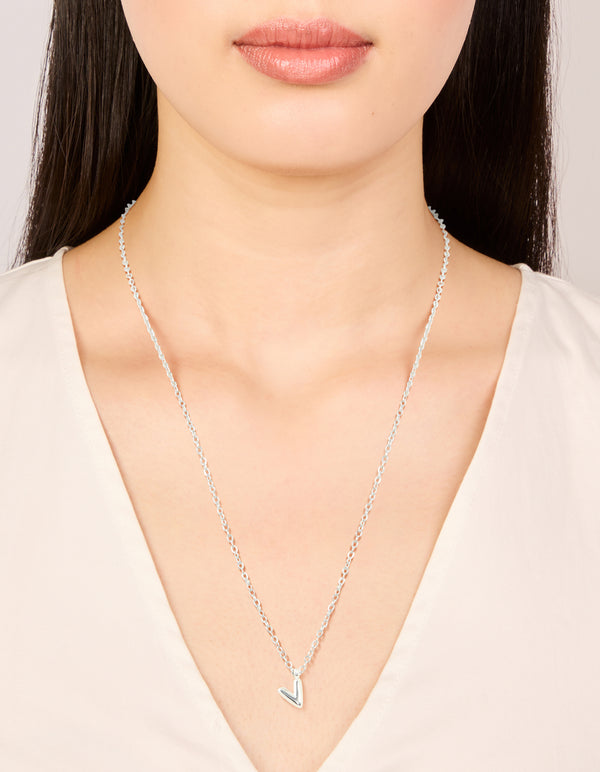 Featuring a waterproof stainless steel mini bubble letter V necklace with initial pendant in silver on neck view