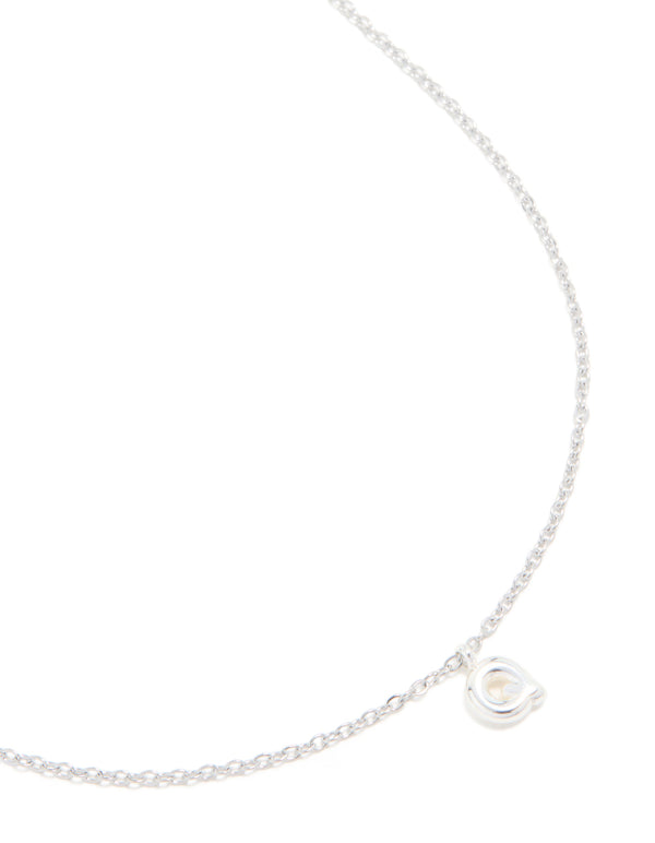 Crafted from waterproof stainless steel, this mini bubble letter Q necklace featuring an initial charm pendant in silver close up view