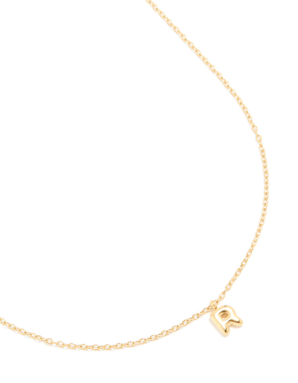 Showcasing a waterproof gold plated stainless steel mini bubble letter R initial pendant necklace with dainty styling close up view