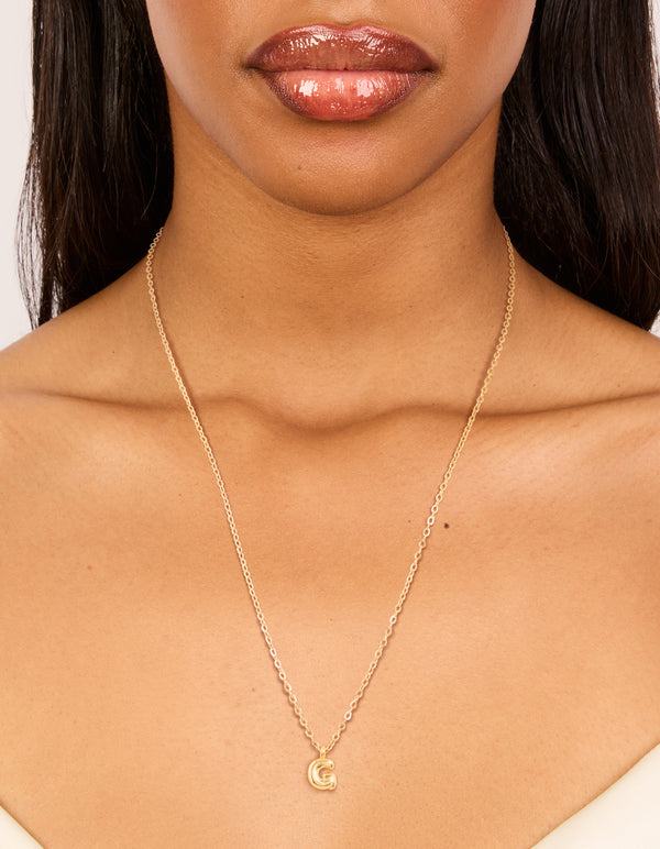 Designed with waterproof bubble letter G necklace in gold plated stainless steel featuring initial pendant on neck view