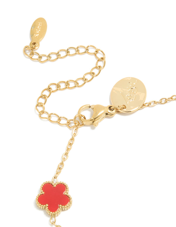 Highlighting a waterproof gold plated stainless steel red shell petal flower charm bracelet closure detail view