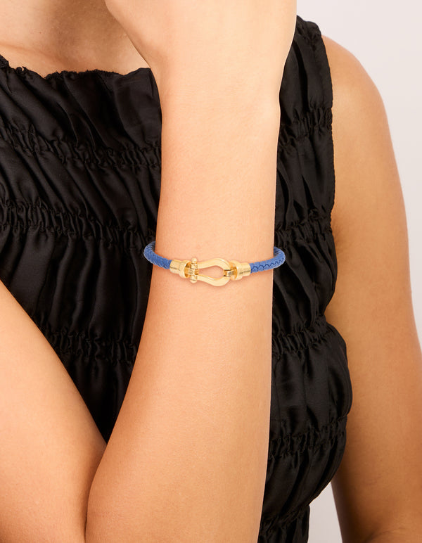 Showcasing a waterproof gold plated stainless steel blue PU leather braided chunky link bracelet in royal blue on wrist view