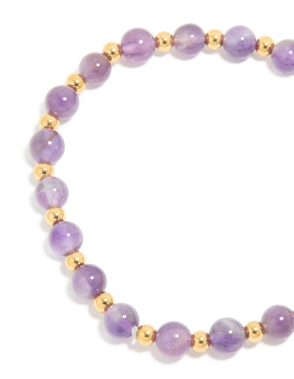 Highlighting the beaded design of waterproof stretch bracelet in amethyst semi precious stone with gold plated stainless steel closure detail view