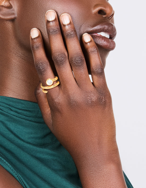 Showcasing a waterproof gold plated stainless steel diamante swirl ring with clear stones on finger view