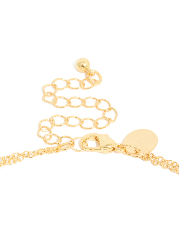 Highlighting the cubic zirconia bezel layered Y-necklace with ball features and gold plated construction in dainty statement style clasp detail view