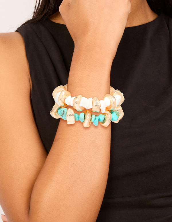 Showcasing beaded stretch bracelets in a 2-pack featuring blue, gold, and white on wrist view