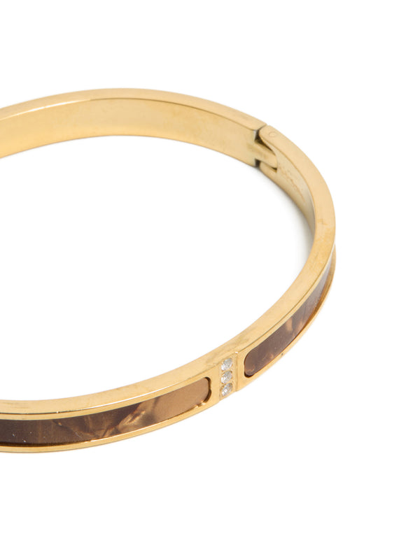 Waterproof gold plated stainless steel hinged bangle with brown pearlised inlay in close up view