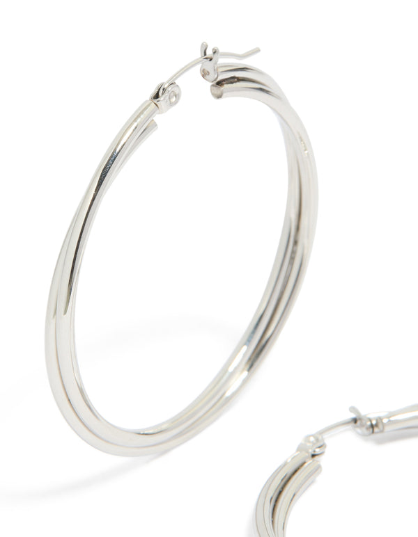 These surgical steel crossover hoop earrings in silver highlight close up view