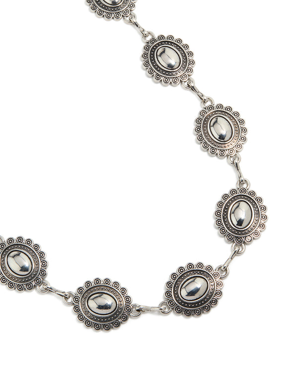 Showcasing an antique silver western scalloped oval belt with embellished waisted design and statement style detail view