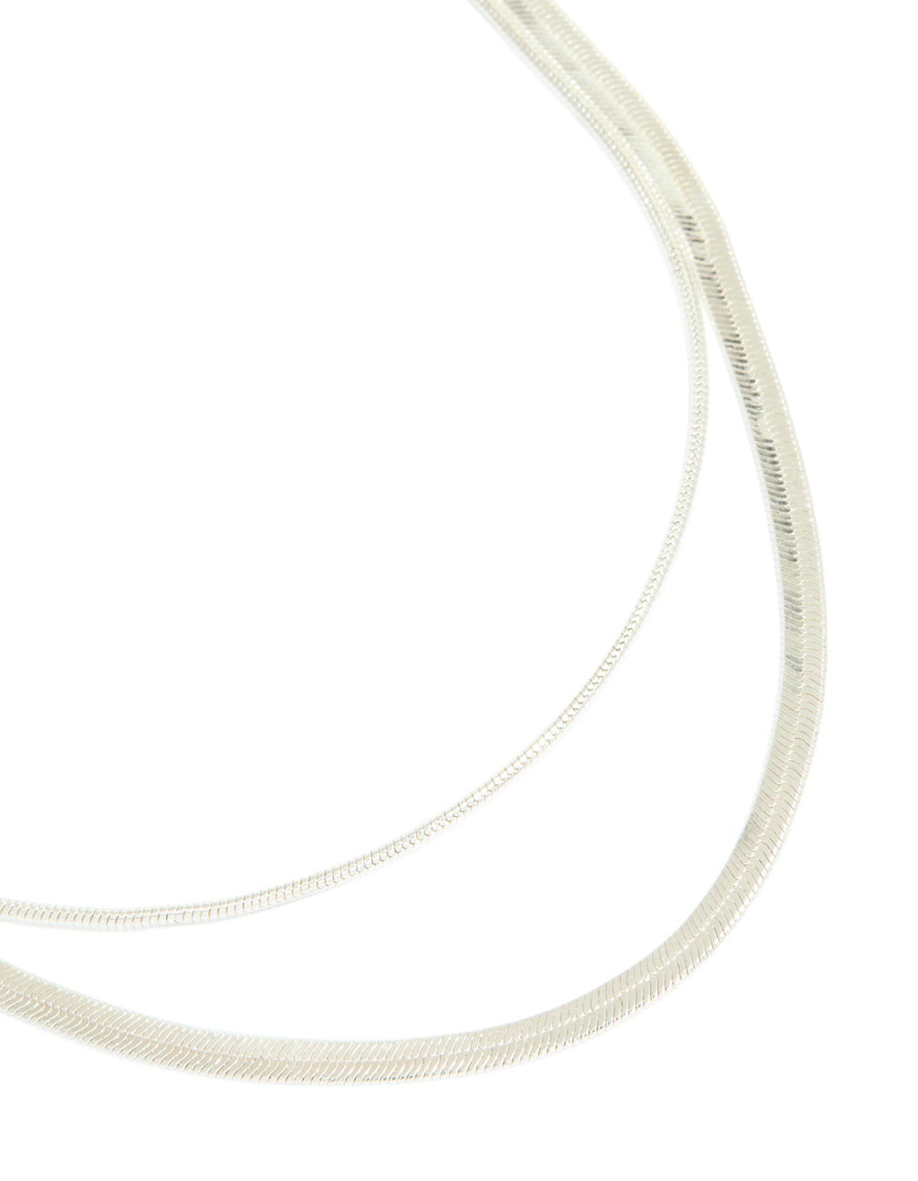 Showcasing a silver plated snake chain layered necklace close up view
