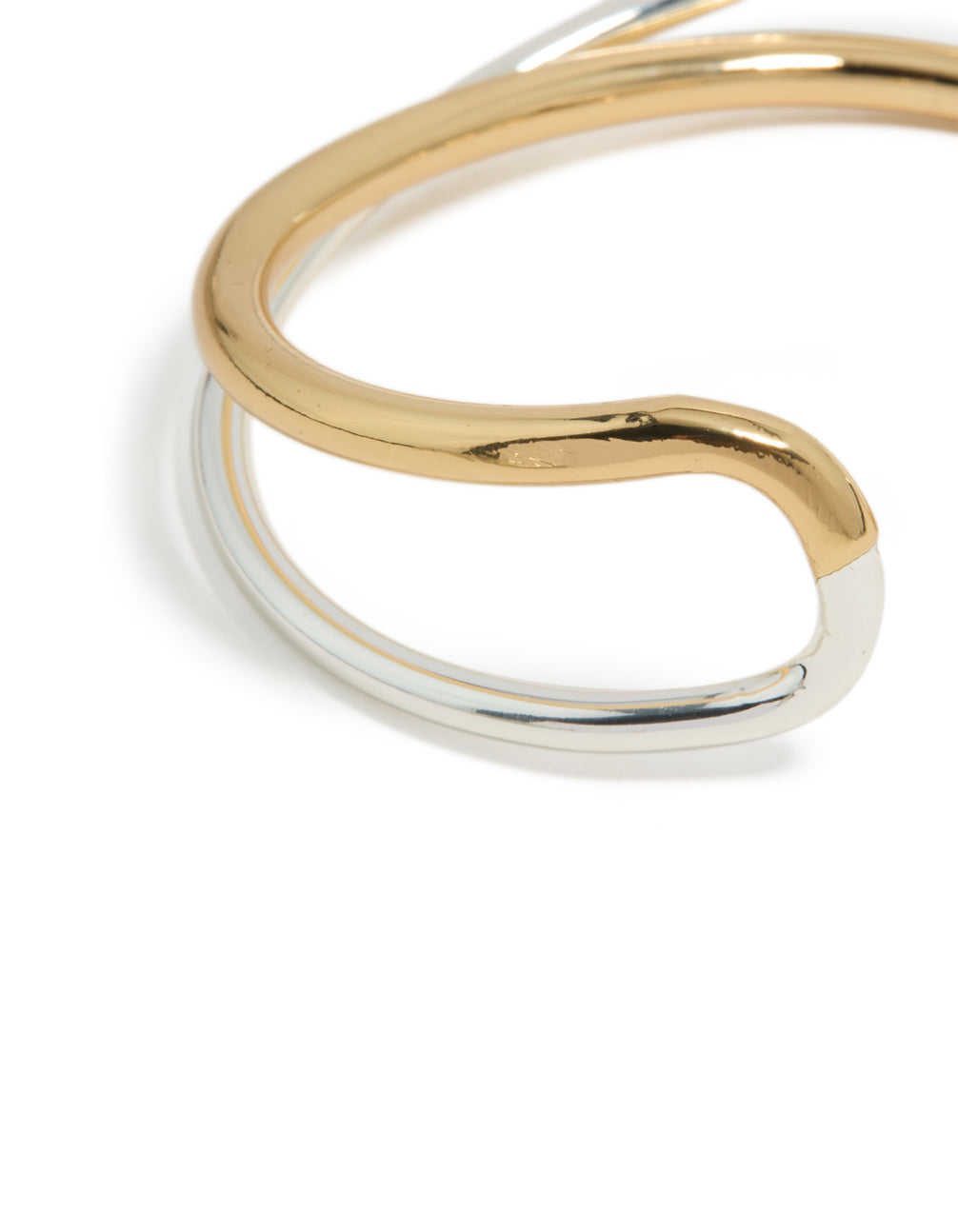 Highlighting a mixed metal open crossover wrist cuff with gold plated and silver finish in bangle form close up view