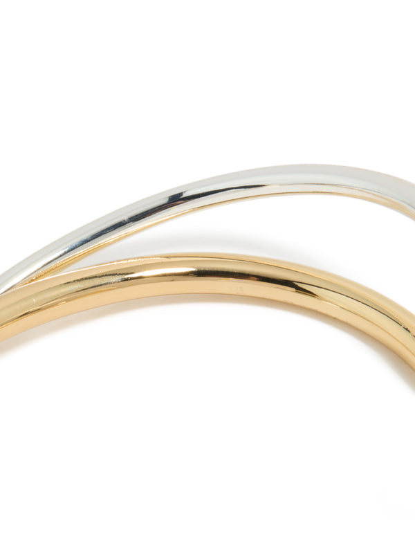 Featuring a mixed metal open crossover wrist cuff in gold plated and silver tones designed as a bangle detail view