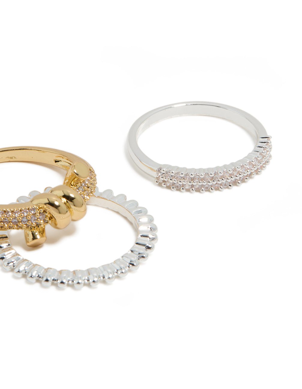 Featuring mixed metal plated cubic zirconia knotted textured rings 4-pack in gold, silver, and clear stone close up view