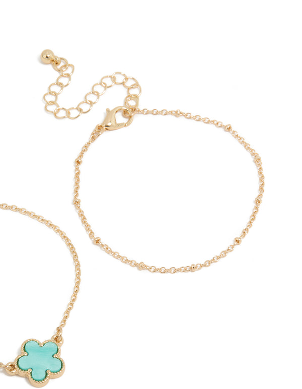 Crafted with floral in gold and turquoise, this 2-pack of bracelets highlights the closure detail view