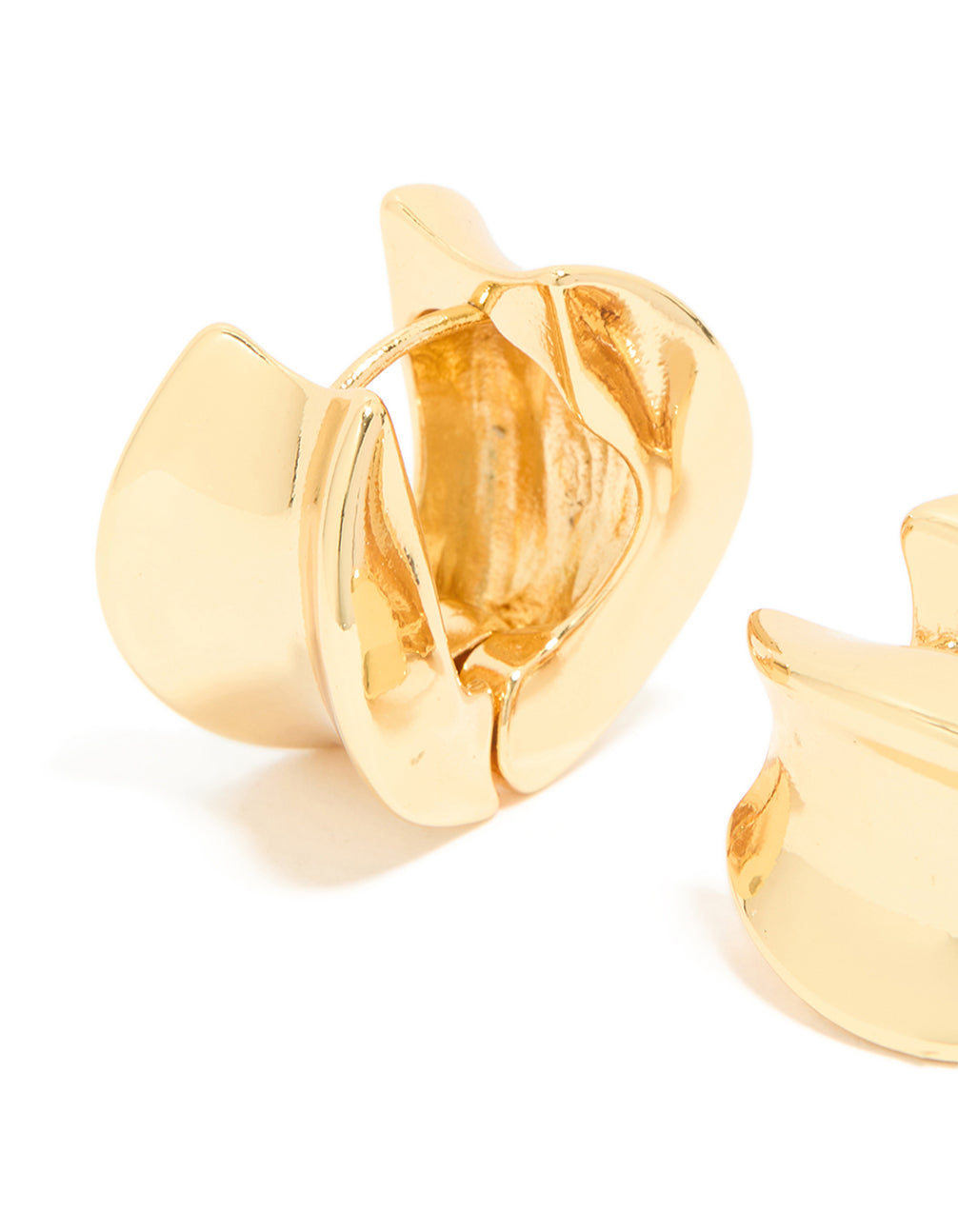 Designed with gold plated finish, organic thick huggie earrings featuring chunky construction close up view