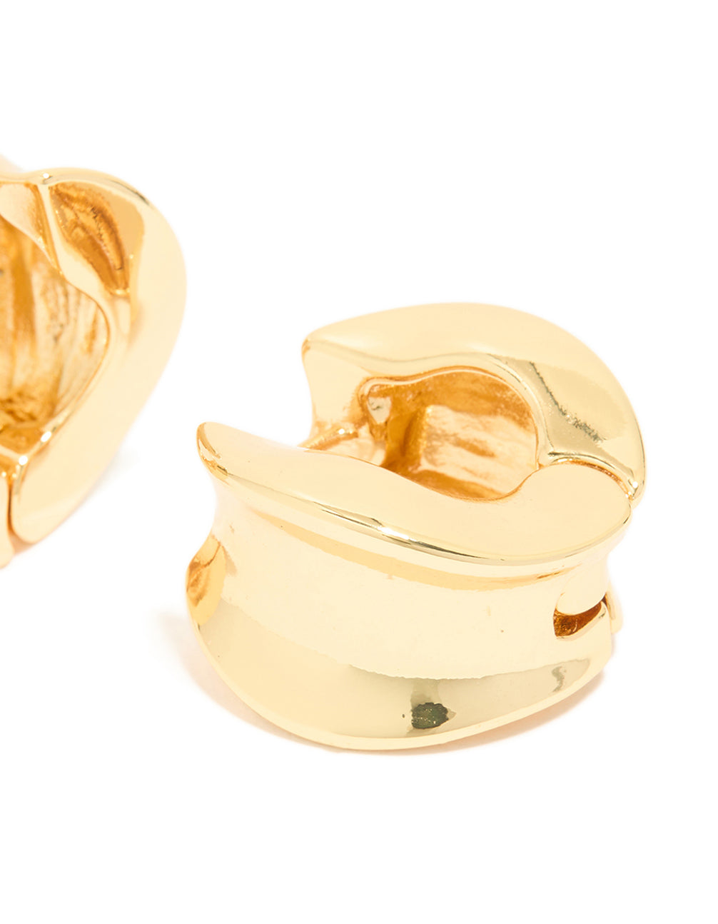 Highlighting gold plated organic thick huggie earrings with chunky style closure post detail view