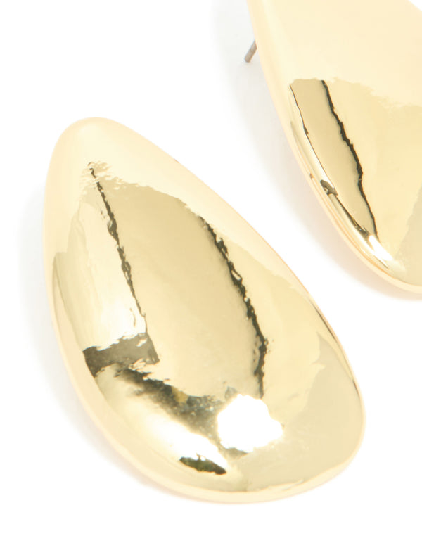 Highlighting gold plated organic teardrop statement earrings close up view
