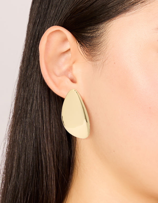 Showcasing gold plated organic teardrop statement earrings on ear view