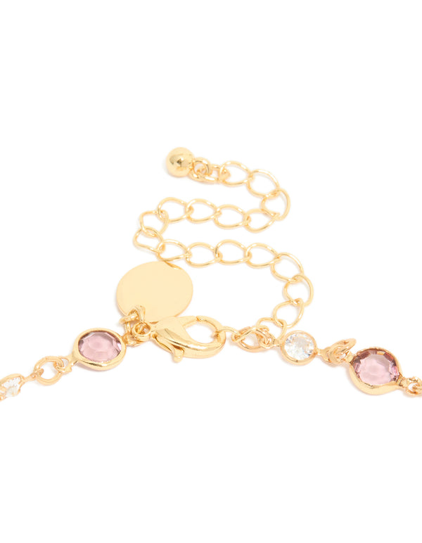 Displaying a gold plated station necklace with pink and clear cubic zirconia stones in round cut clasp detail view