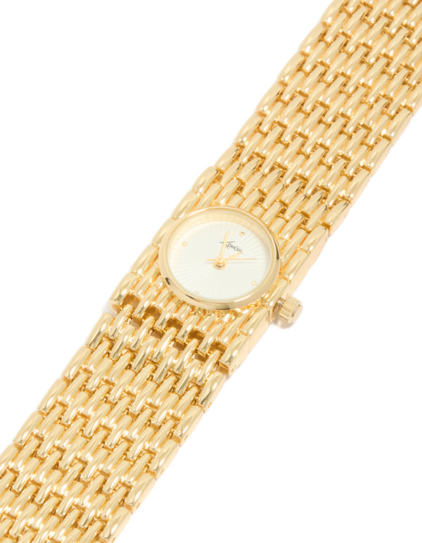 Elegant women's chunky statement bracelet watch with white dial look with stone, round shape, analog display, link band in gold, and casual occasion styling watch face detail view