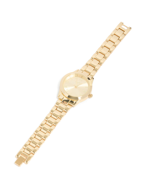 Crafted with roman numeral numbers gold dial round shape formal analog link-band strap gold plated statement watch for women front view
