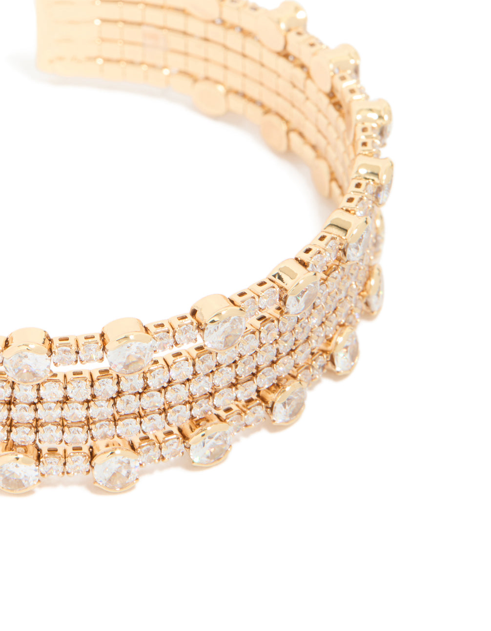 Highlighting a gold mini bezel set cubic zirconia wrist cuff close up view