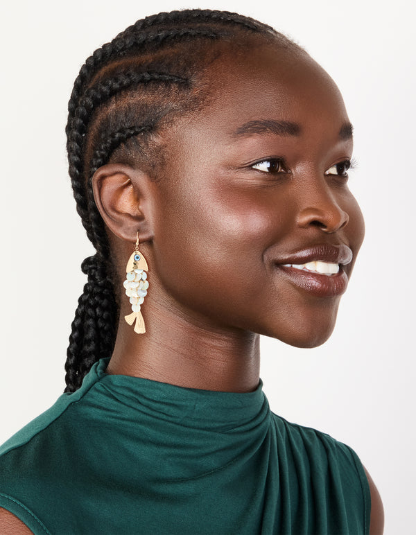 Designed with gold these evil eye fish drop earrings featuring animal and ocean inspired charm in statement style on model view