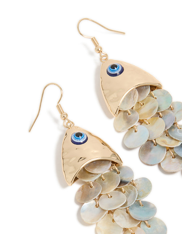 Featuring gold evil eye fish drop earrings with animal and ocean inspired charm in statement style close up view