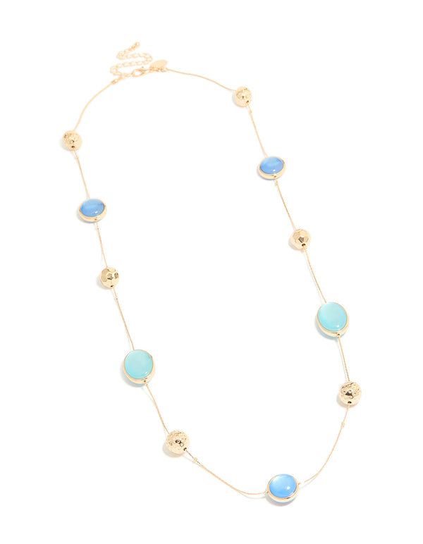 Showcasing a gold long blue beaded necklace with textured balls and statement style front view