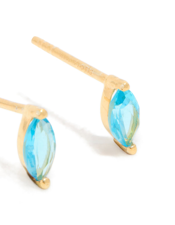 Highlighting the craftsmanship of blue marquise cubic zirconia earrings with gold plated sterling silver posts and engraved detail view