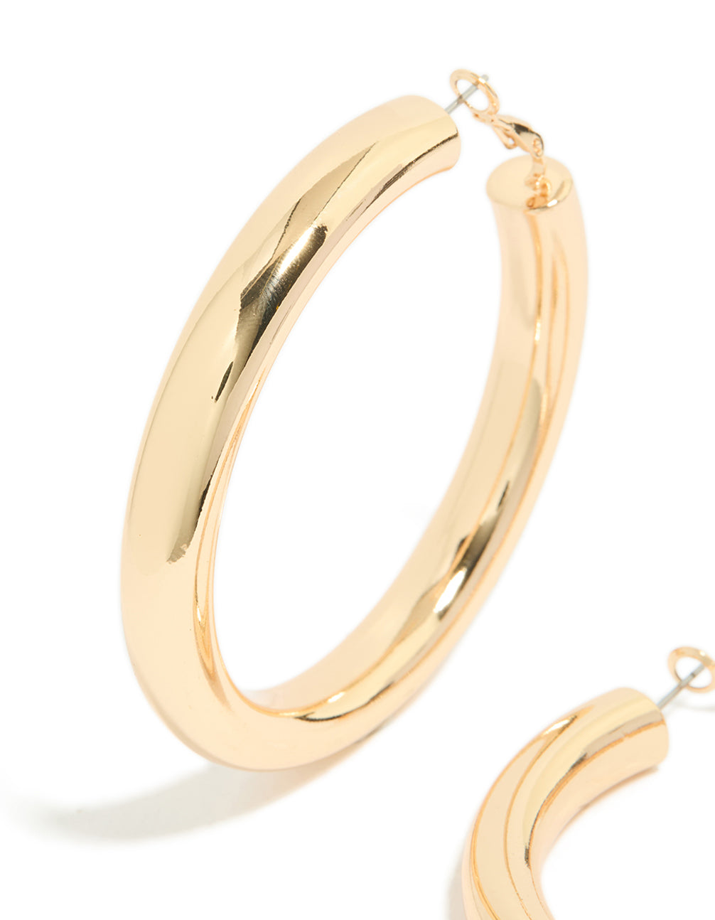 Featuring gold large thick hoop earrings with statement style in a close up view