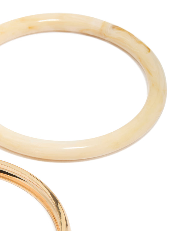 Showcasing gold and blue acrylic stackable bangle bracelets in a 4-pack close up view
