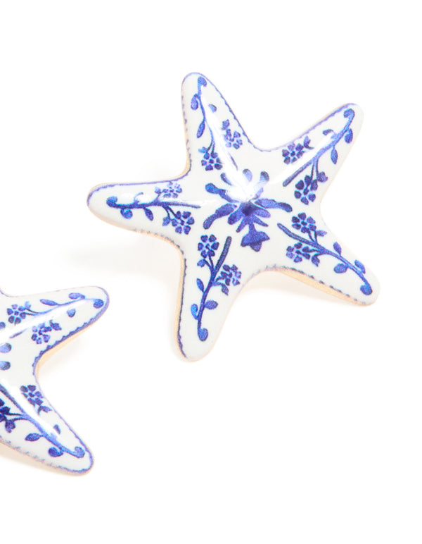 Designed with painted starfish stud earrings featuring floral and ocean accents in white and blue close up view
