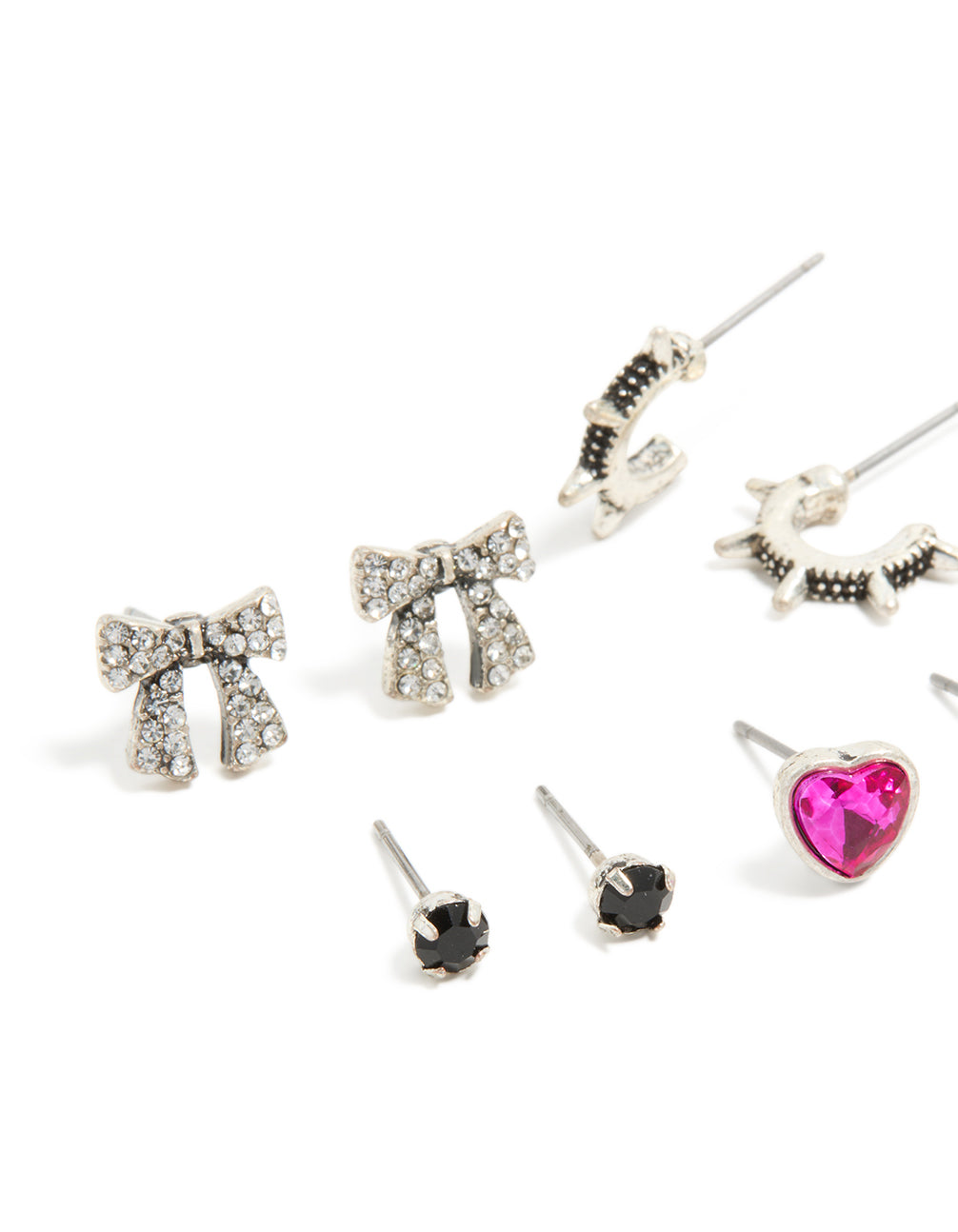 Crafted from silver, this bow, heart and cross earrings 6-pack showcases stud closures in fuchsia, black and white accents close up view