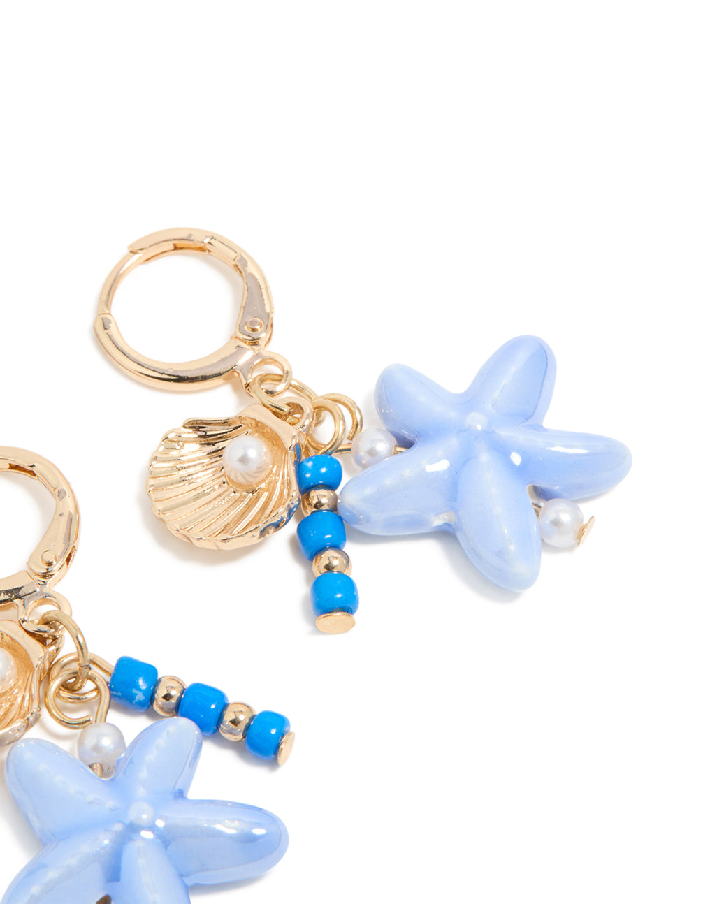 Crafted from gold, these sea life charm huggie earrings feature ocean-inspired shell, beaded accents, pearls, and starfish accents in a post detail view