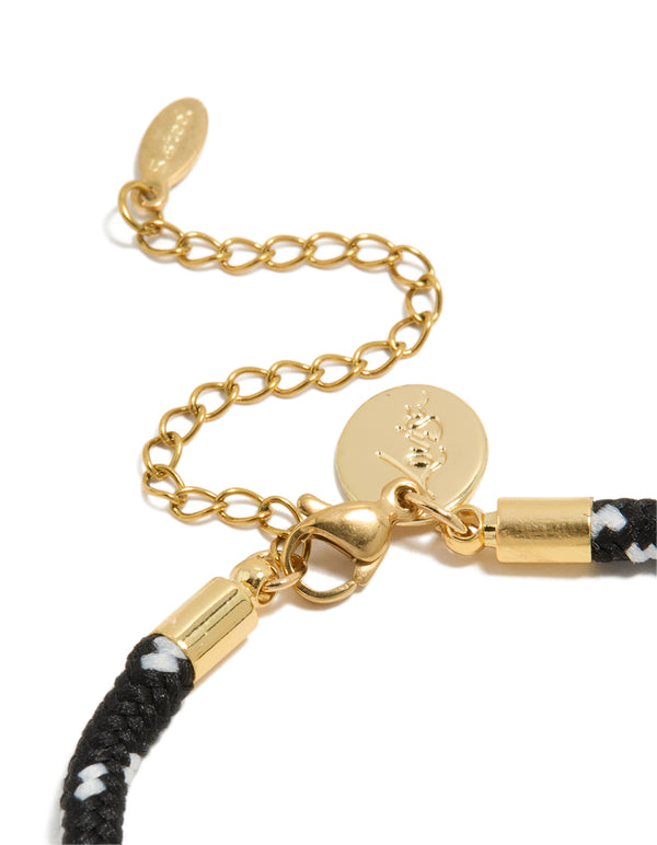 Highlighting the waterproof half tennis and black cord bracelet made from gold plated stainless steel and cubic zirconia in statement style closure detail view